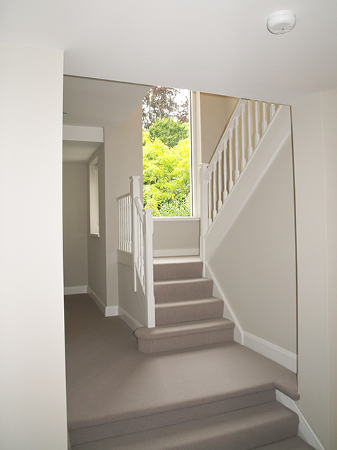 Bright well lit staircase with maximum window space to mature garden