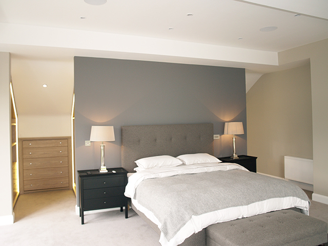 Master bedroom with walk-in wardrobe and hidden en-suite to rear of bed