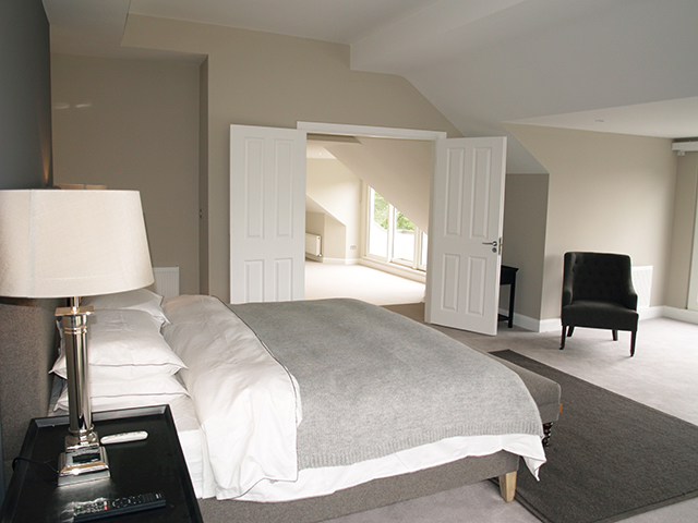 Spacious master bedroom looking out on split level landing