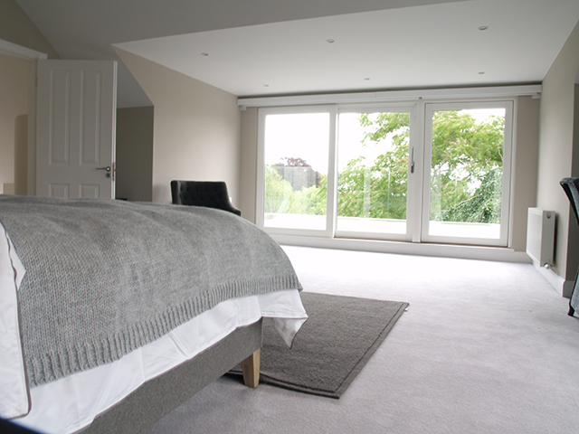 Master bedroom with floor to celing sliding doors to balcony