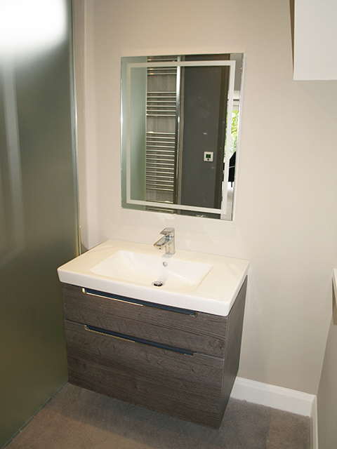 Towel warming feature behind mirror in master bed en suite