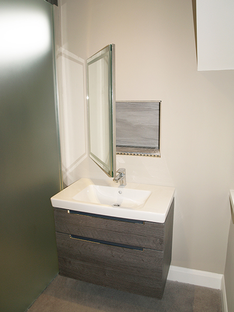 Towel warming feature behind mirror in master bed en suite