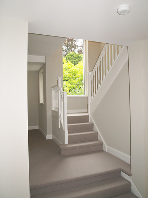 Bright well-lit staircase with maximum window space to mature garden