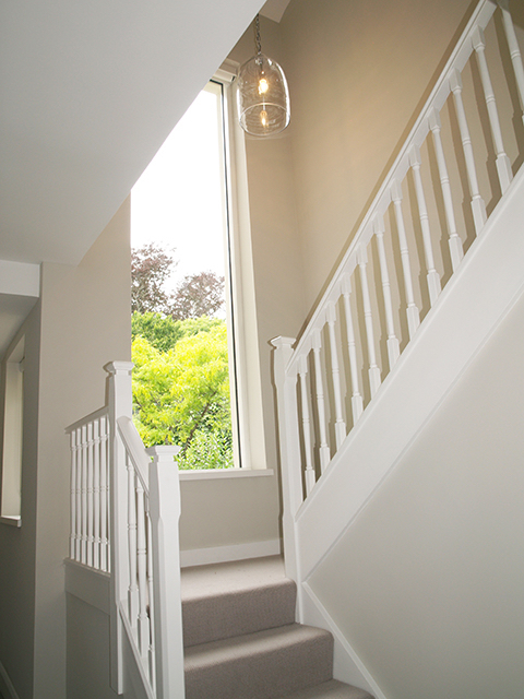 Bright well-lit staircase with maximum window space to mature garden