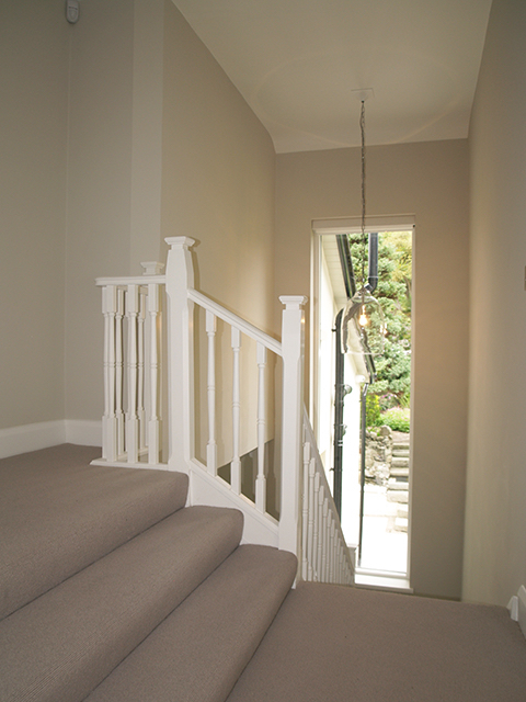 Bright well-lit staircase with maximum window space to mature garden