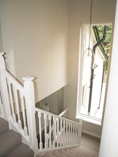 Bright well-lit staircase with maximum window space to mature garden