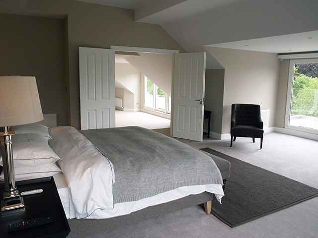 Master bedroom with floor to ceiling sliding doors to balcony