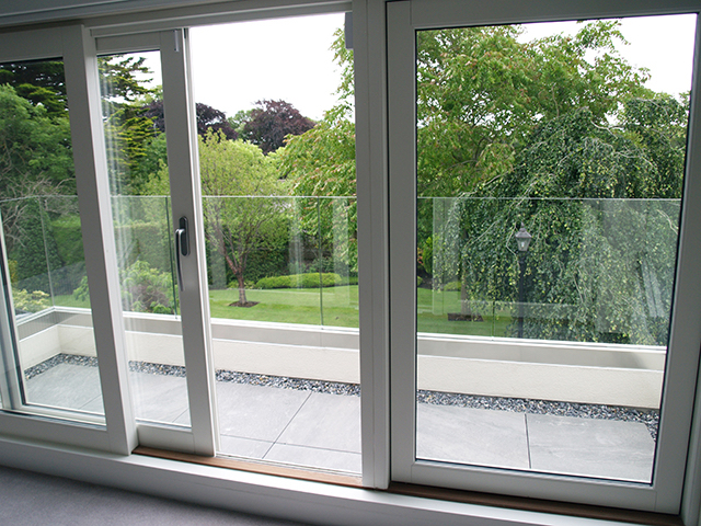 Large floor to ceiling sliding doors to upstairs balcony