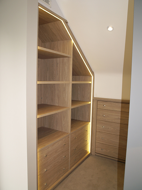 Walk in wardrobe to left of master bed with feature strip lighting