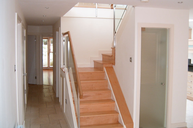 Central dog leg stairs, glass door storage